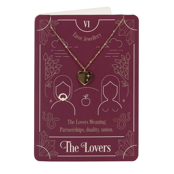 Gold-tone heart necklace on greeting card with metallic envelope.